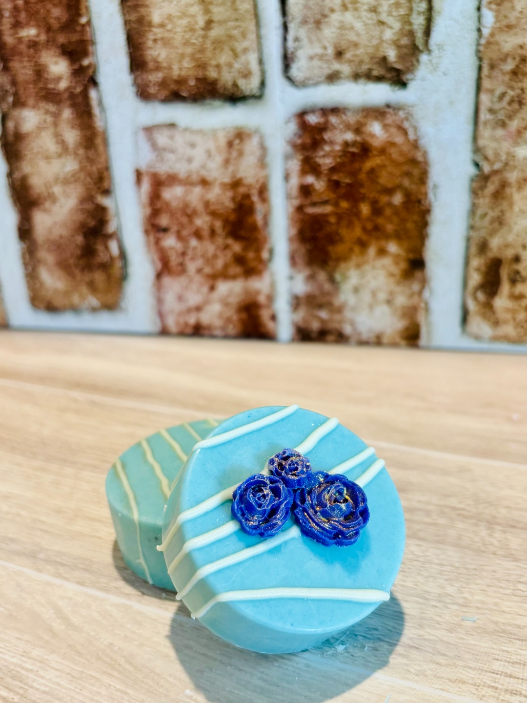 Light blue chocolate Oreo with dark blue rose decorations
