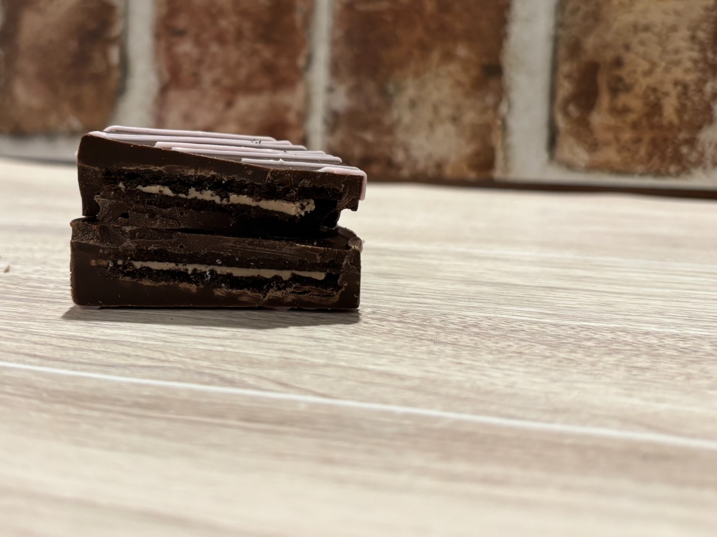Cross-section of a chocolate covered Oreo showing the filling
