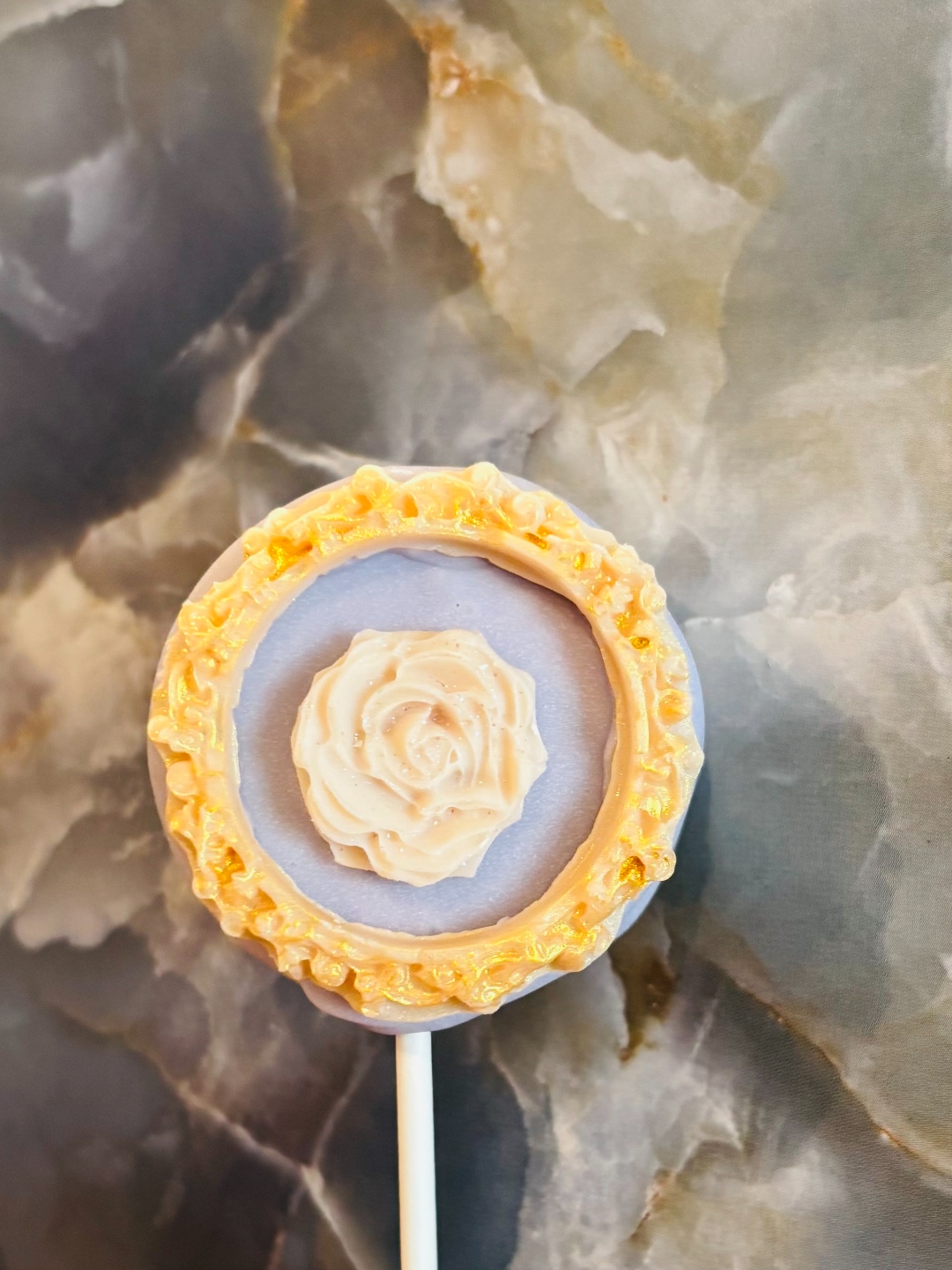 Lavender chocolate Oreo with edible gold frame and white rose detail
