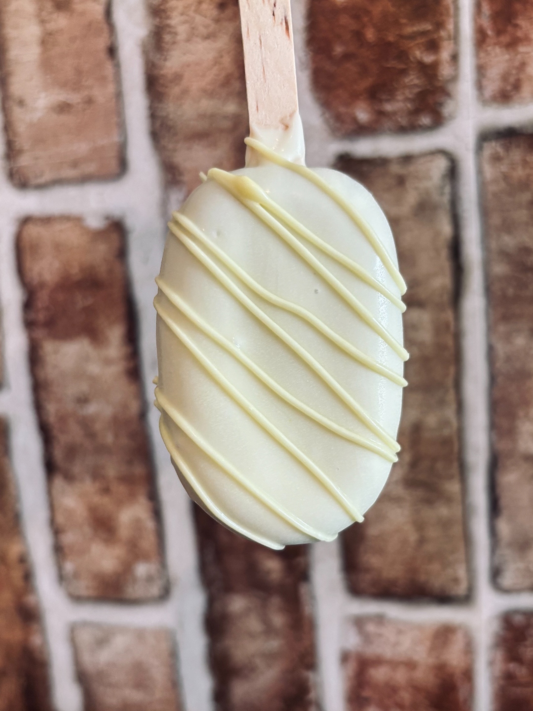 White chocolate cakecicle with cream drizzle